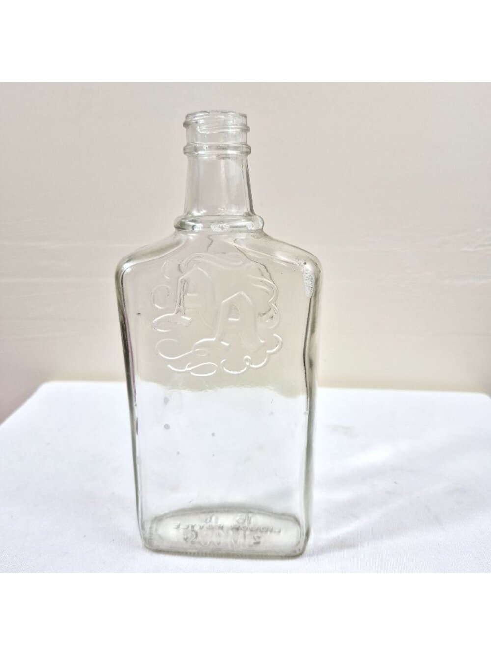 Vintage AA Embossed Glass Liquor Bottle Flask Shape 200ml Clear Empty